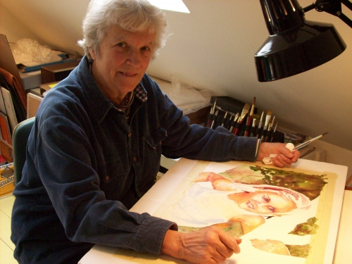 Anne Tedeschi painting at a desk